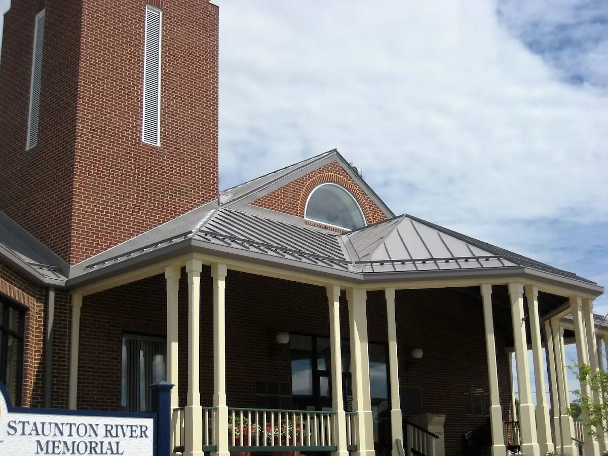 Skilled roofing craftsmen working on a residential roof in East Milton